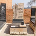 Close-up of angel and cross carvings on a granite tombstone in South Africa